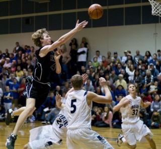 John Gage throws in two points over Cascade Christian’s defense on Jan. 10.