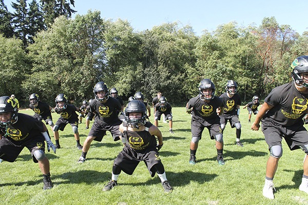 Members of the Vashon High School Pirates football team practicing and end of game routine.