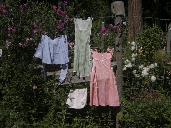 A few of the aprons that will grace an exhibit at Vashon-Maury Island Heritage Museum hang on a line.