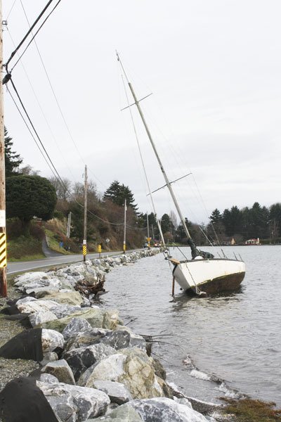 A sailboat washed ashore along S.W. Quartermaster Drive.