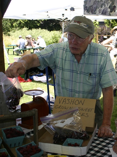 Bob Norton offers up some cherries at Saturday’s market.