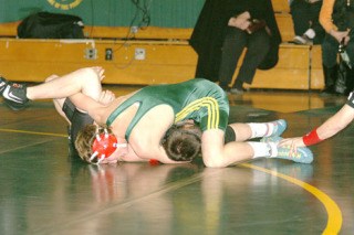 Pirate Eddie Protzeller needed only one minute and 21 seconds to pin Rainier’s Michael Davis in the 130-pound class.
