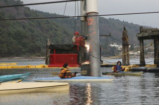 Islanders kayak directly next to a construction crew at the Glacier Northwest site Wednesday afternoon.