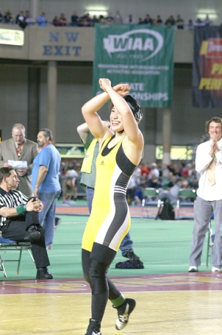 Sylvie Shiosaki salutes Vashon fans after winning her second consecutive state wrestling championship at Mat Classic XXI.