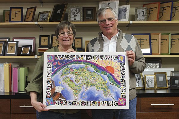 Donna Kellum and Michael Soltman hold a poster now on sale to benefit the VHS class picture restoration project. The posters can be purchased for $10 each at Frame of Mind.
