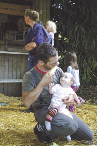 Web Crowell of Seattle shares an ear of corn with a friend