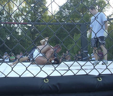 Two fighters battle it out at Saturday’s cage-fighting event.