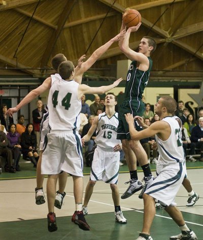 Alex Wegner shoots for two points over a crowd of Charles Wright Tarriers.