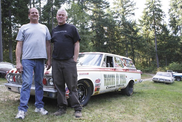 Mike Brenno and Chris Barnes stand in front of their prized station wagon