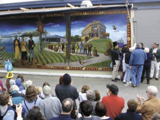 Descendants of people depicted on the mural pull the cord on Saturday