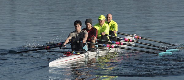 Junior and master rowers row together in a Saturday race; from left to right they are Connor van Egmond