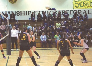 Pirates libero Jessica Pirruchio (in white jersey) prepares for her save and pass during the Cascade Christian match.