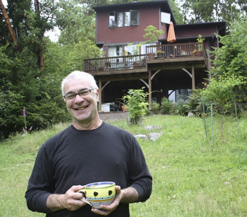 Michael Rosenberg stands outside his south-end home