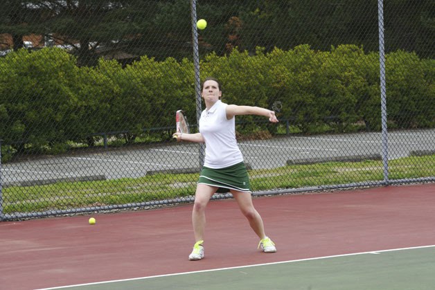 Alex Wall attacks a volley on the way to a win against Cascade Christian at a recent home tennis match.