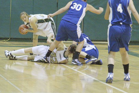 Kiki Means grabs a loose ball knocked away from North Mason by Chrissy Swope