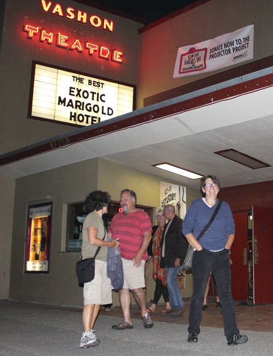 Moviegoers leave the Vashon Theatre on Monday.