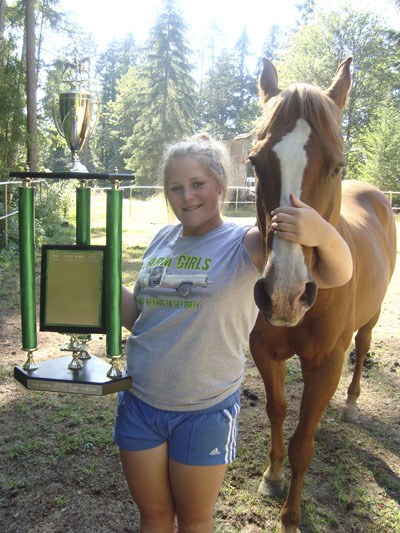Taylor Shride won an enormous trophy for her horsemanship while riding Bandit.