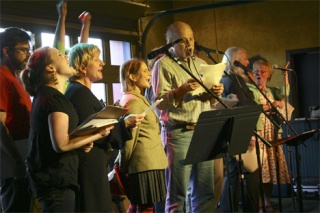 Jeff Hoyt (center) leads the Church of Great Rain’s Holy Roller Radio Players.