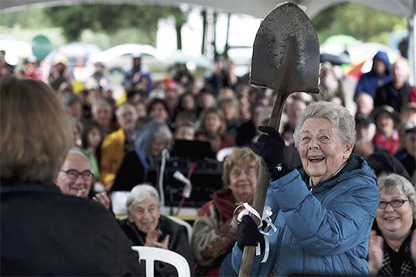 Kay White holds up a decorated shovel she was given during the groundbreaking ceremony for the Vashon Center for the Arts.