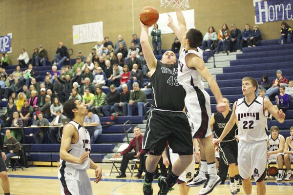 Kyle Bakker draws a foul shooting over a Hoquiam defender late in the first half of Saturday’s game.