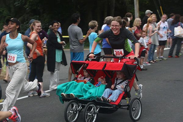 Jennifer Gogarten inspires awe in onlookers and competitors as she runs the 5k race pushing a triple stroller.