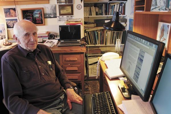 Wendell Tangborn sits at his home office on Vashon. From his PC