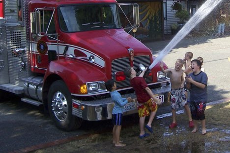 Firefighter Jason Everett estimated more than 100 Island kids took advantage of Wednesday's 'community cool-off.'