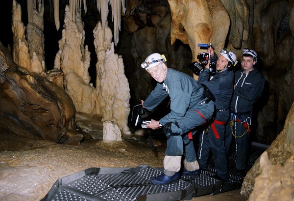 Werner Herzog and a film crew step inside Chauvet Cave