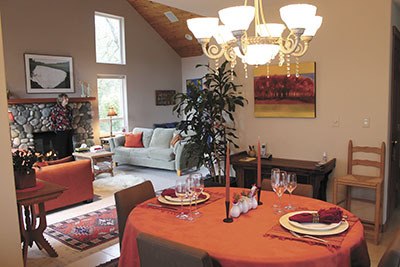 A crystal chandelier hanging in Hanmer's dining room symbolizes wealth of friendship or money. The living room beyond it is designed to be a welcoming place.