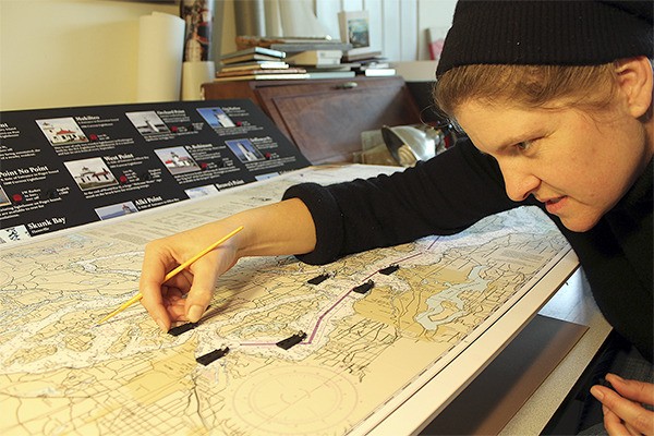 Jessica DeWire shows an interactive map she’s creating of Puget Sound lighthouses for the heritage museum’s upcoming exhibit on the Point Robinson Lighthouse.
