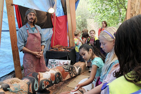 Vashon artist Odin Lonning tells a group of second graders about the totem poles he is carving.
