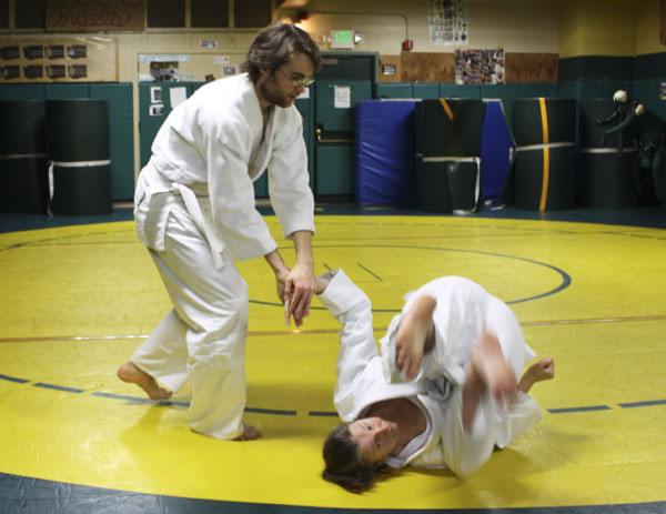 Liam Rockwell takes down Lisa Macleod during Aikido practice last week in the Vashon High School wrestling room.