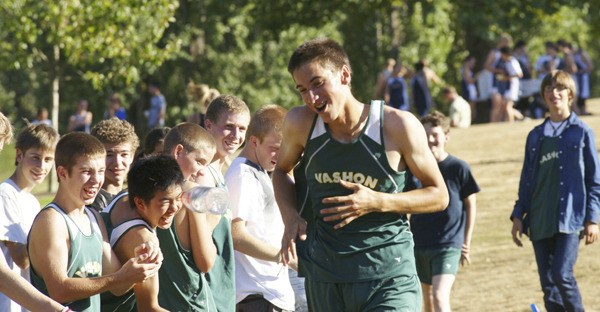 Junior Phillip VanDevanter reacts to the cheers of Pirate teammates as he nears the finish line at Thursday’s jamboree.