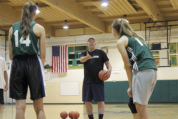 Girls’ basketball coach Rob Kearns talks to players during a practice last week. He hopes the 50-year-old gym they play in will soon be upgraded.