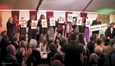 Supporters of the Vashon Center for the Arts take to the stage at VAA’s annual art auction last month.
