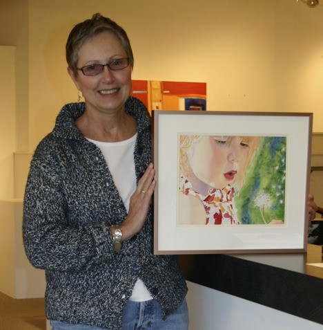 Donna Botten displays one of her paintings