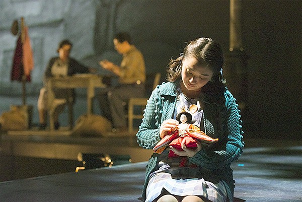 A young Japanese-American girl plays with a Hina-Matsuri doll in “An American Dream.”