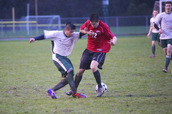 Vashon’s Gerardo Pereyda-Antune (left) and Archbishop Murphy’s Quin Nelson go one-on-one for control of the ball in the mud on Thursday.