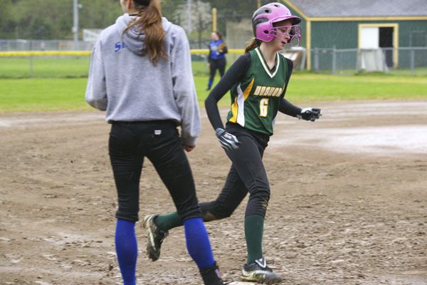 Lauren Ockinga rounds third base on the way to scoring Vashon's first run in a muddy game against Cascade Christian.