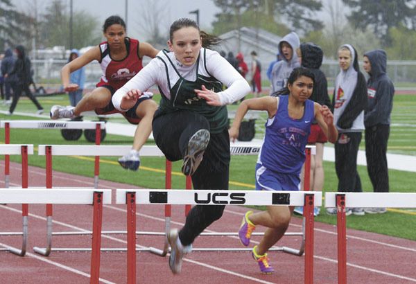 Pirate senior Taylor Hernandez holds a good lead as she goes over the final hurdle in the 100-meter race at Orting on Thursday.