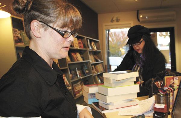 Jenni Wilke sells a stack of discounted books to a longtime customer.