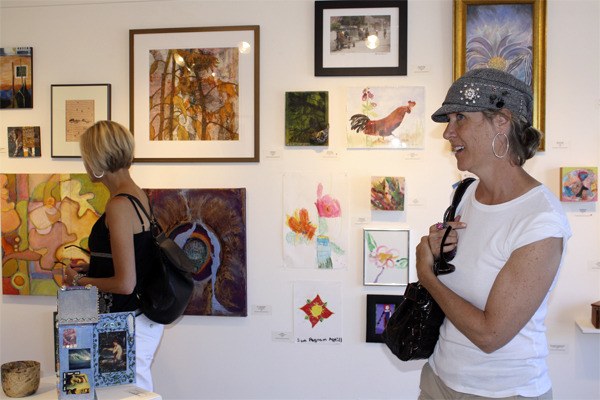 Two gallery-goers check out the all-Island show at VALISE.