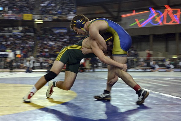 Vashon High School senior Chester Pruett (left) attempts to take down his opponent during a state championship match last weekend at the Tacoma Dome.