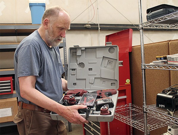 Steve Graham holds a drill that will be available to borrow from the Vashon Tool Library.