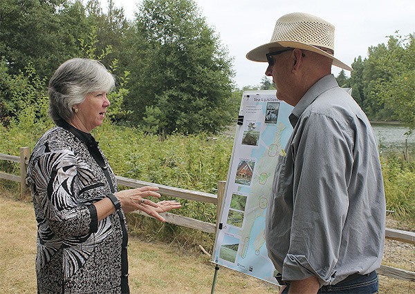 State Sen. Sharon Nelson talks to land trust Director Tom Dean before Friday's press conference.