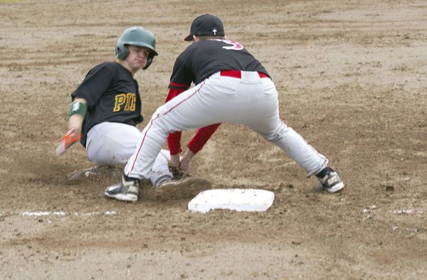 Peter Johnson almost beats the tag at third base as he tries to stretch an RBI double into a triple in Friday’s baseball game.