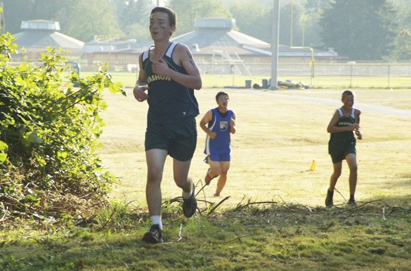 Vashon's Teddy Atwell leads teammate Harper Whitney and a Cascade Christian runner over a transition on the Pirates' new cross country course midway in Thursday's home meet.