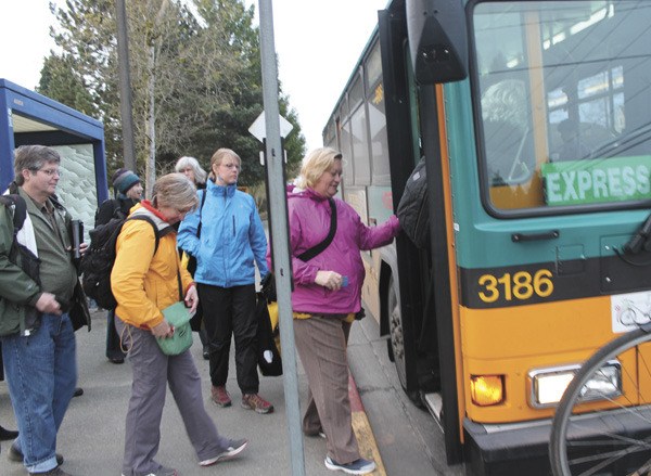 Islanders get on a bus in Vashon town early Tuesday morning. The county may make reductions to Vashon’s bus service as early as this fall.