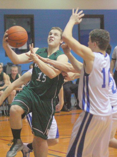 Matthew Dick (15) shoots a layup on the way to Vashon’s win over the Chimacum Cowboys last Tuesday.
