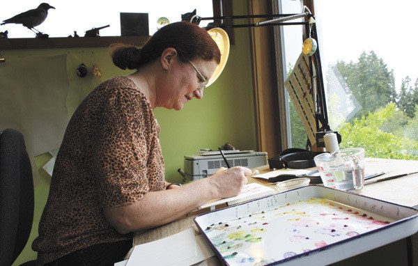 Jean Emmons paints in her studio at her home near the Dilworth Loop.